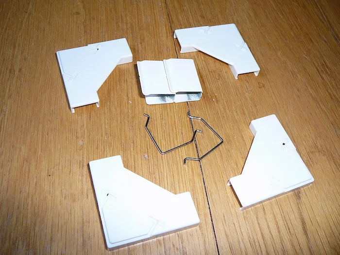 Corner brackets and wire spring clips supplied with the magnetic flyscreen window